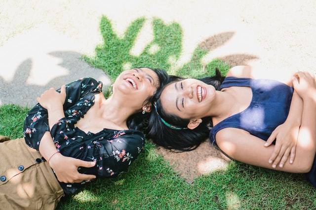 two woman laughing in field benefits of cochlear implants