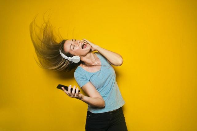 woman dancing with headphones hearing loss aging