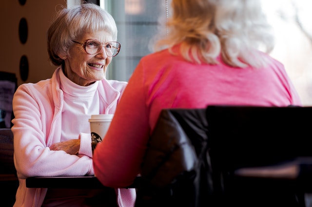 Old Woman Sitting And Talking OTC Hearing Aid Effective over the counter hearing aids benefits and risks 