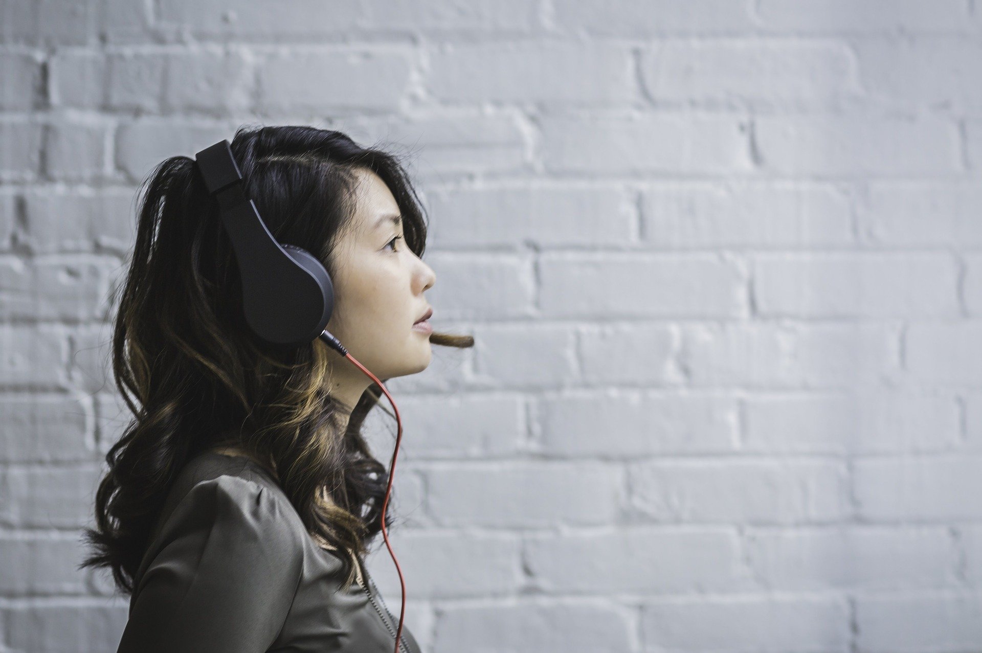 woman with headset hearing loss signs