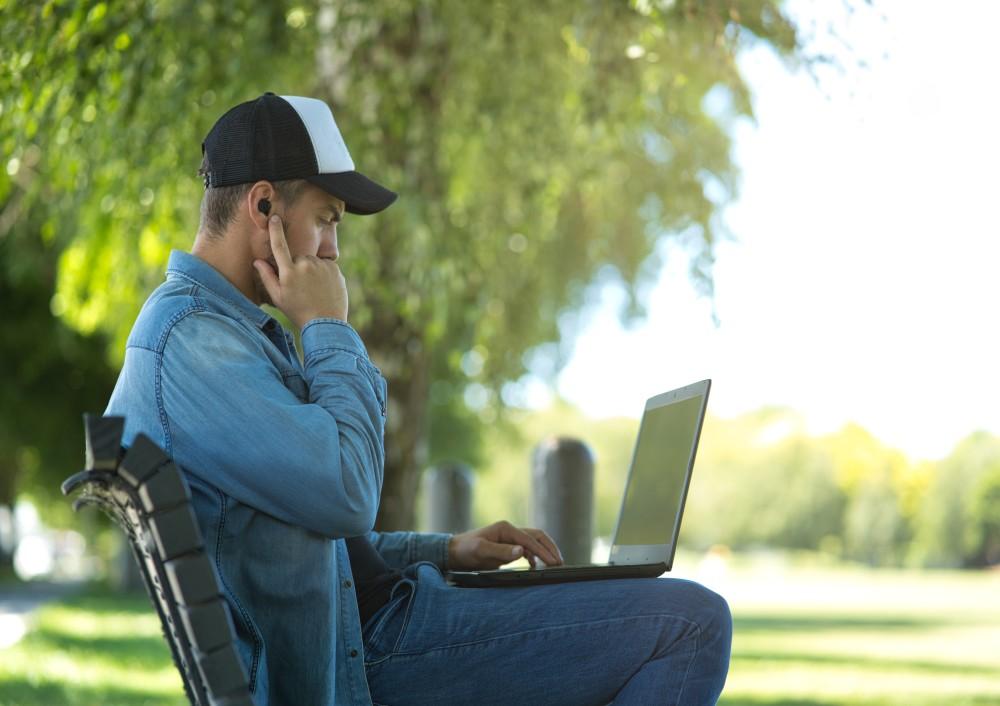 Sitting On Bench With Earbuds