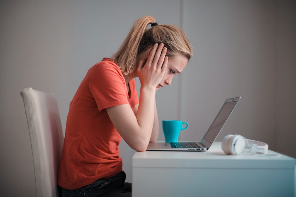 woman looking at laptop untreated hearing loss