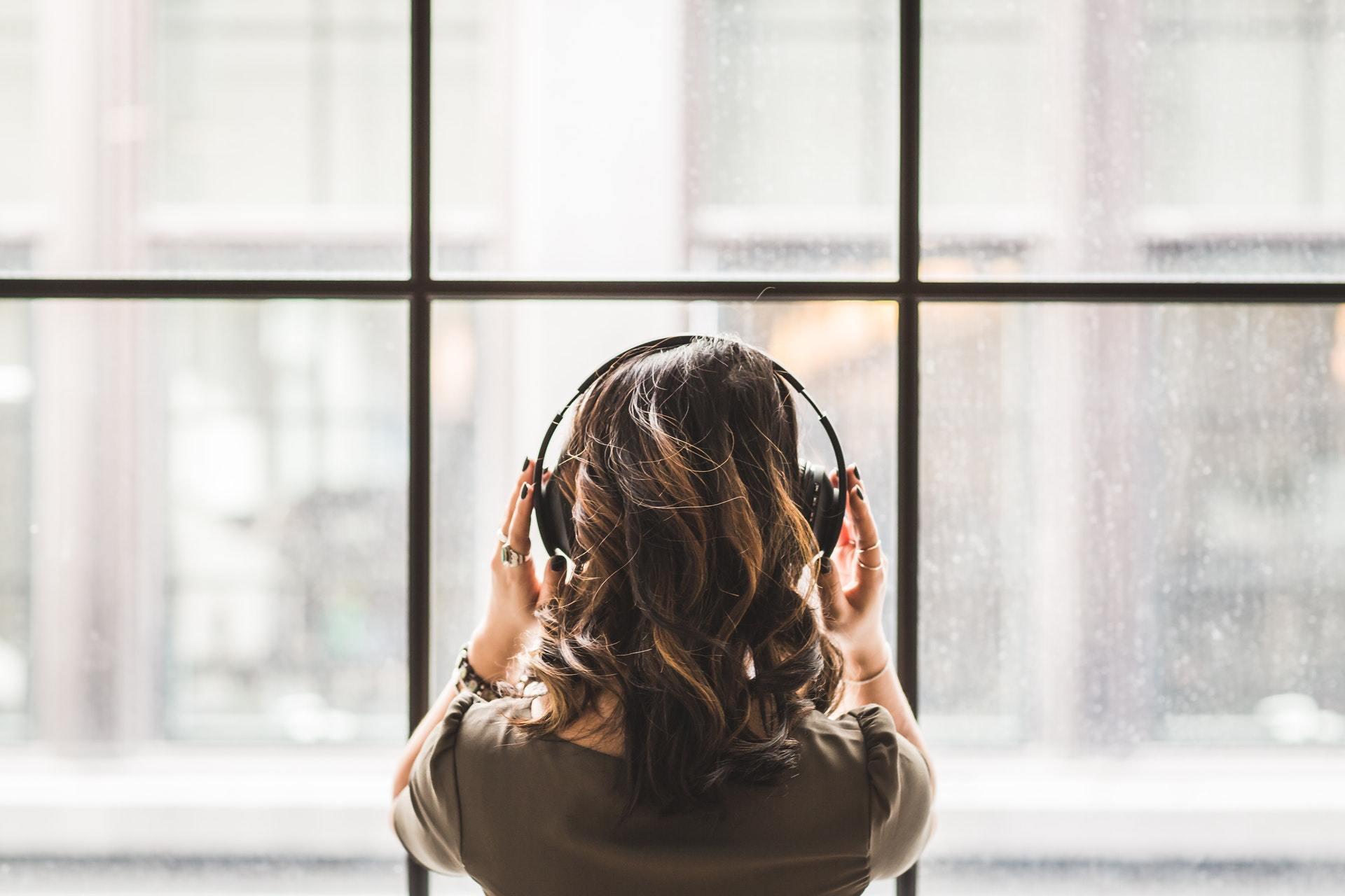 woman with headphones hearing aids and amplifiers for tinnitus