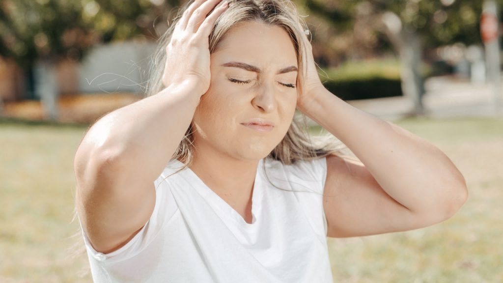 Woman with headache tinnitus