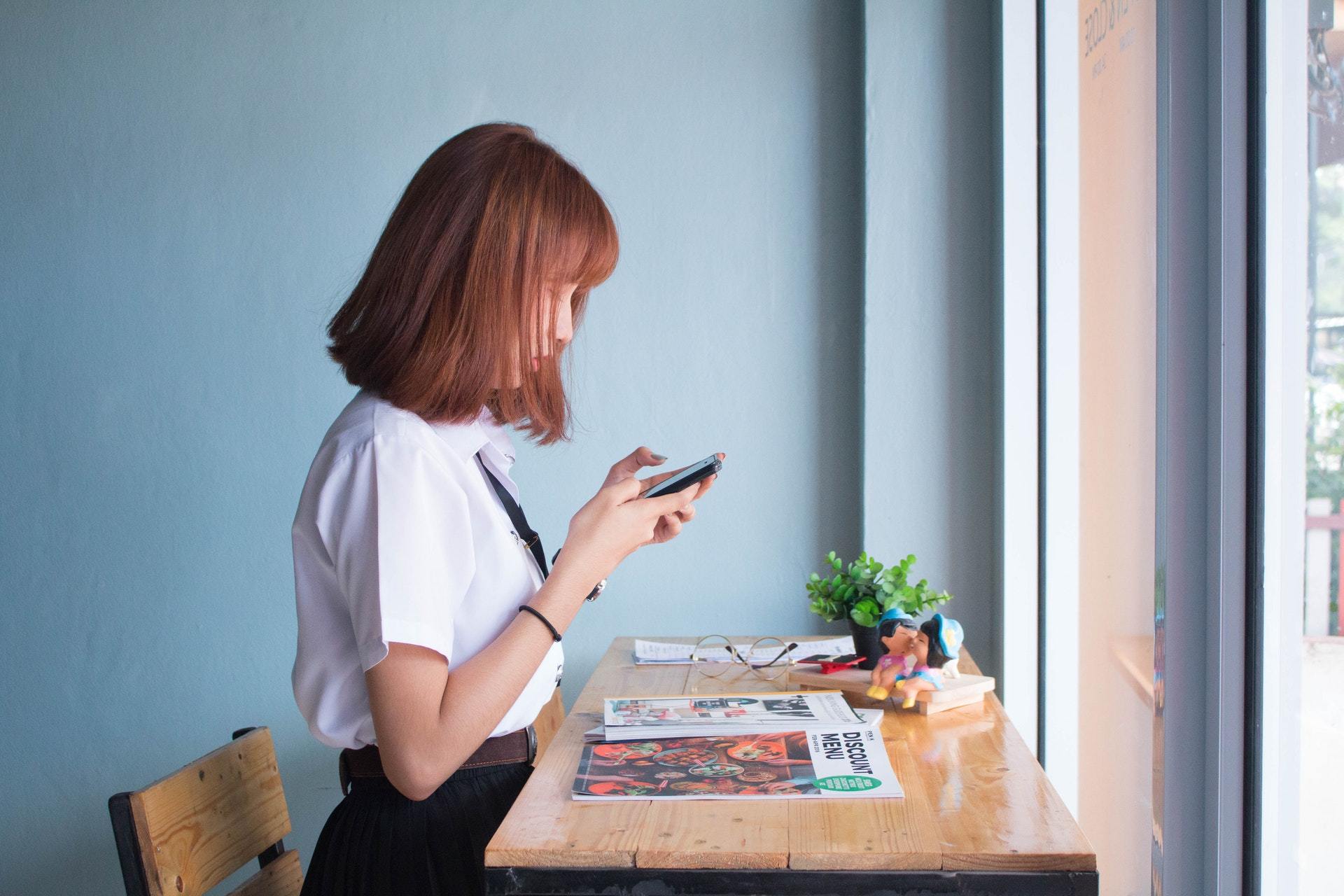 Woman Using Smartphone Apps for Hearing Loss