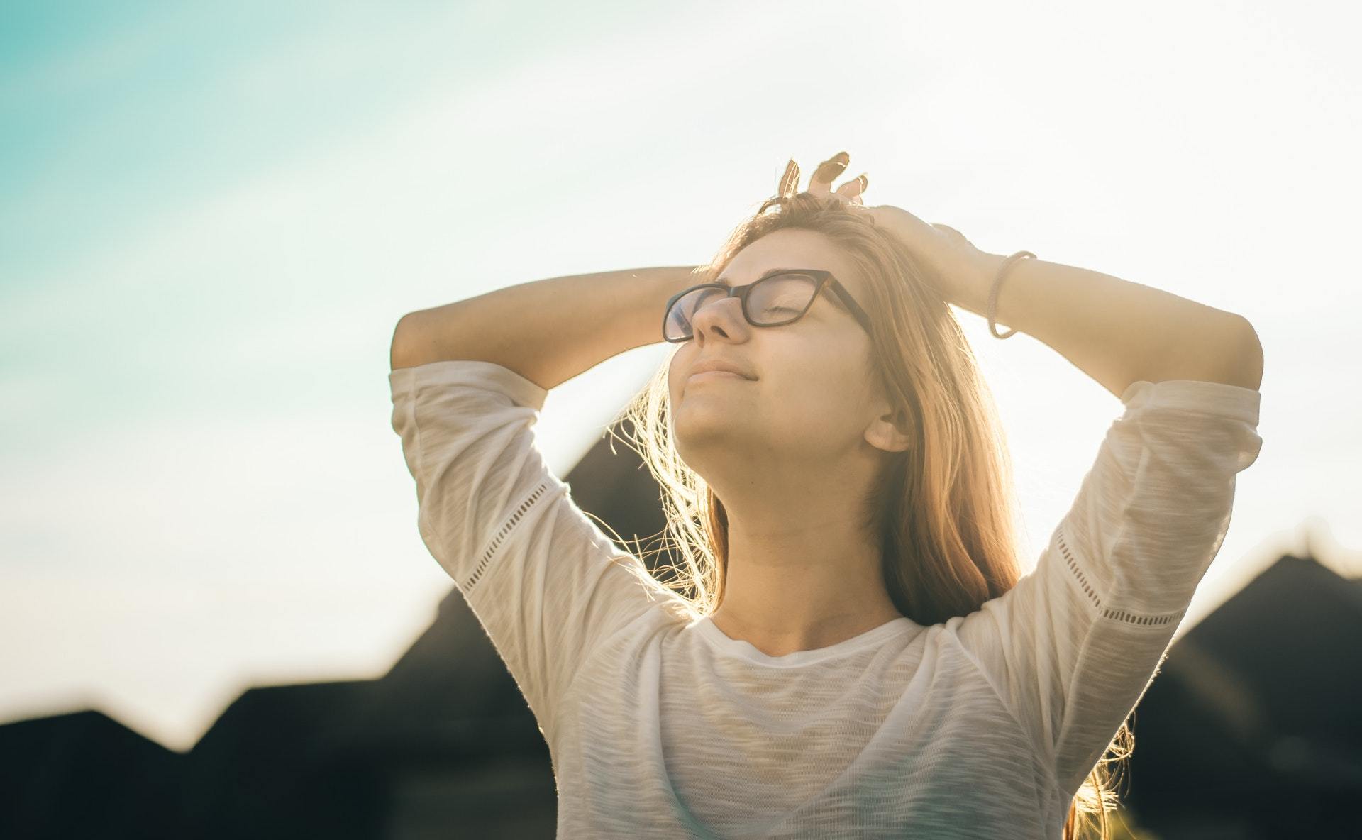 woman basking in sunlight prevent hearing loss