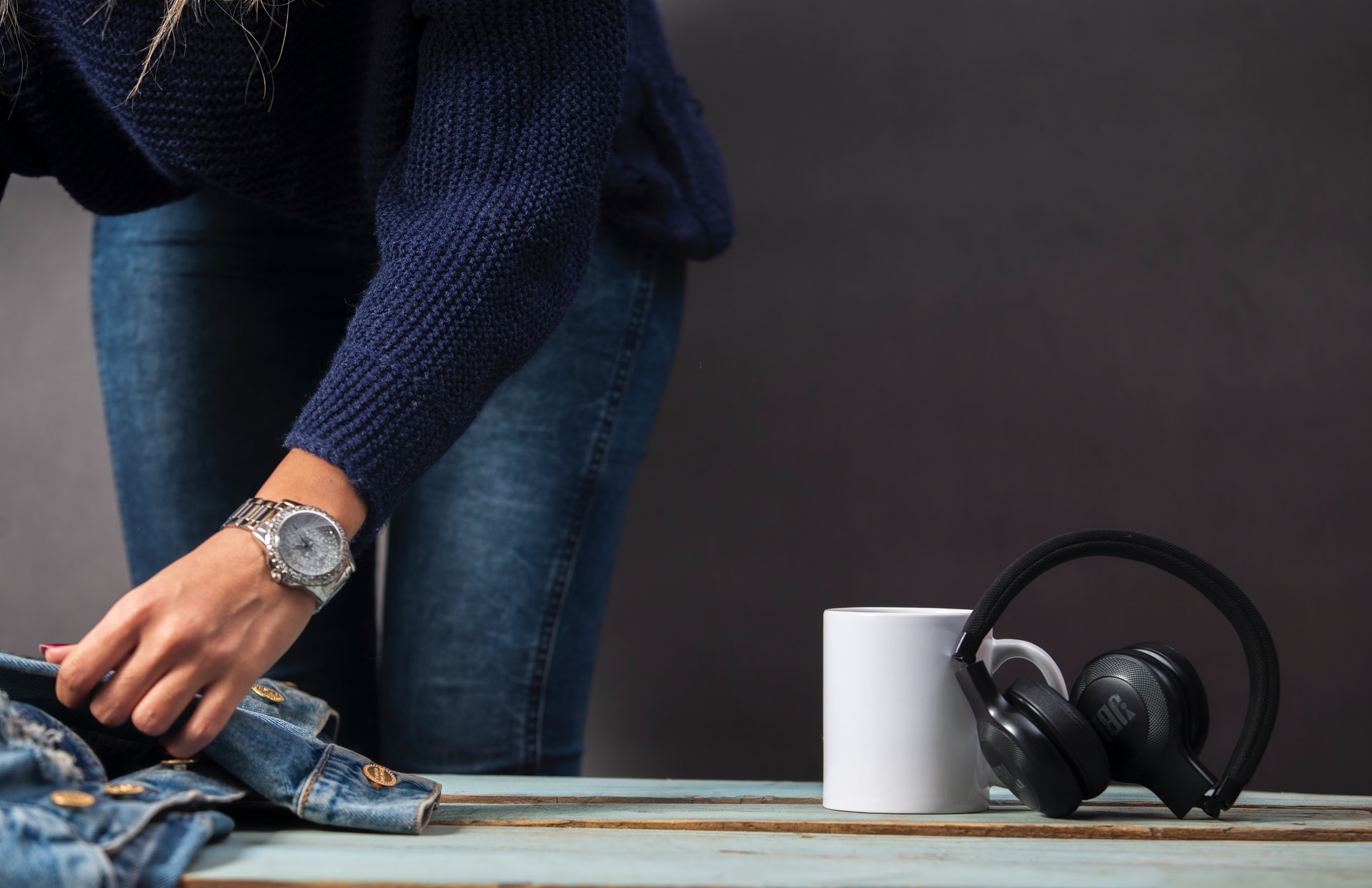 Woman Folding Clothes And Headphones For Tinnitus Sound Therapy