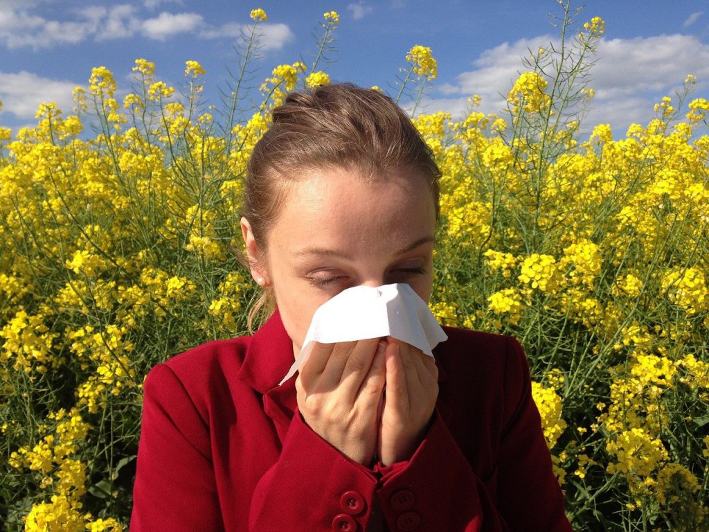 woman with allergies clogged ears from cold