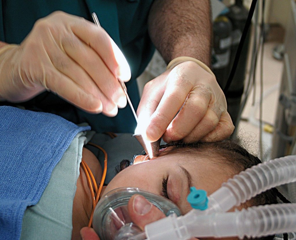 woman ear inspection ent vs audiologist