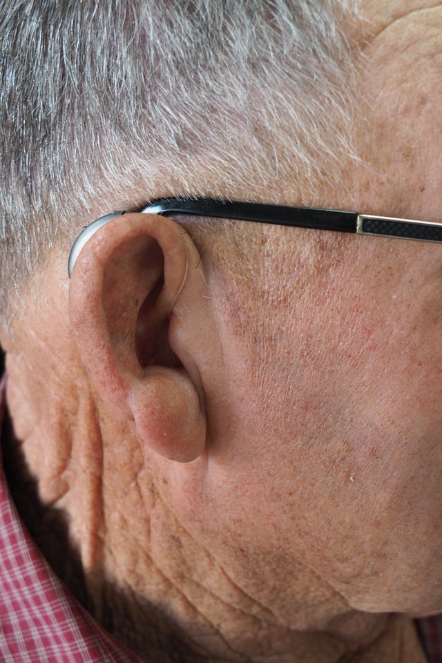 man wearing hearing aid ric hearing aid