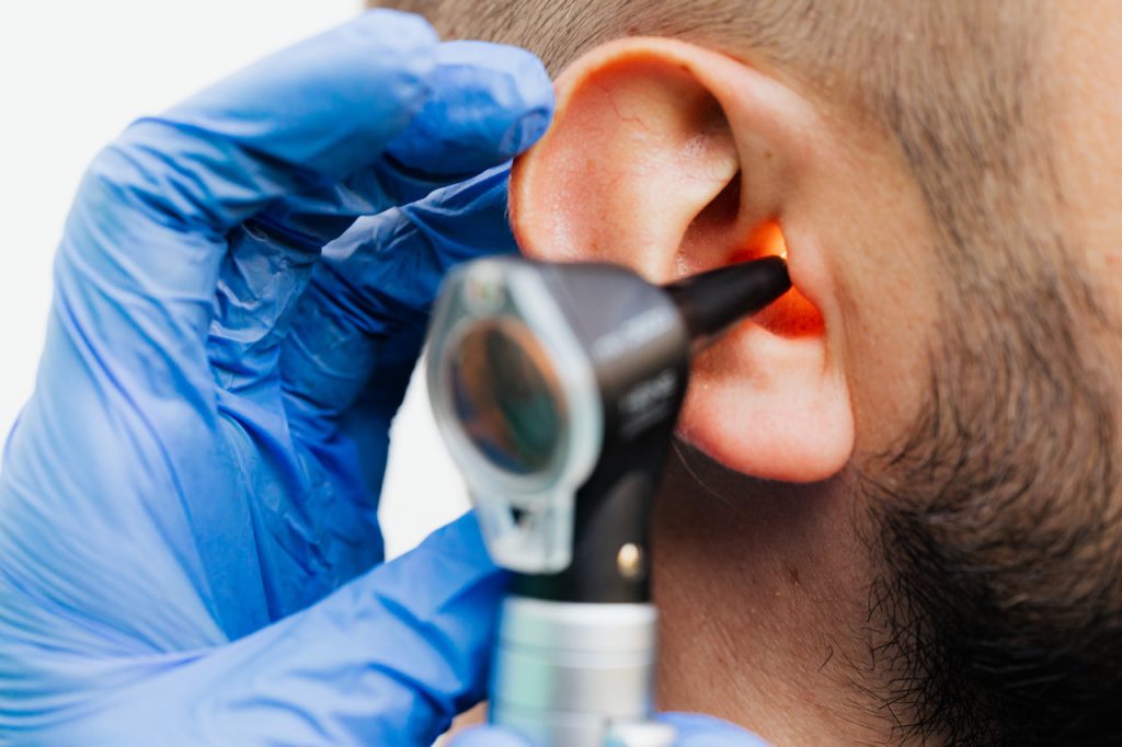 man receiving hearing test ric hearing aid