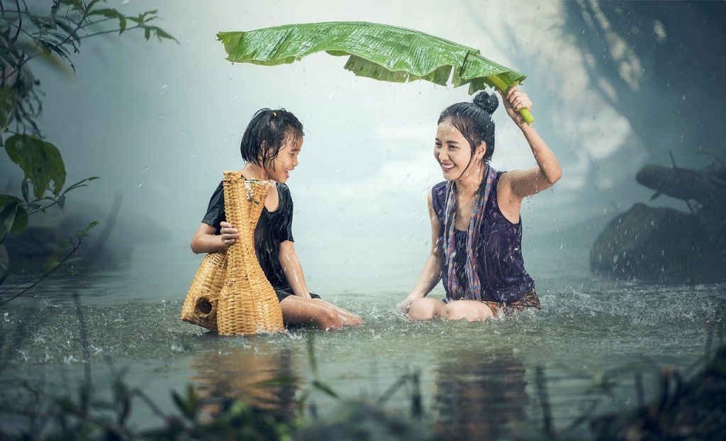 woman and kid in rain Hearing Aid Maintenance