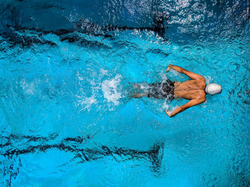 man swimming How to clean hearing aids