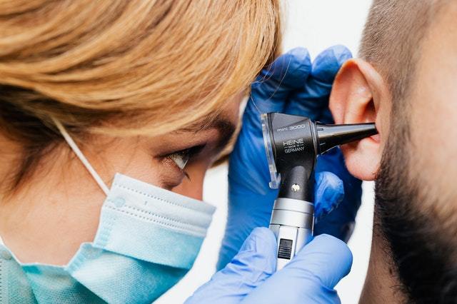 Doctor Examining Ear Hearing Loss Cure