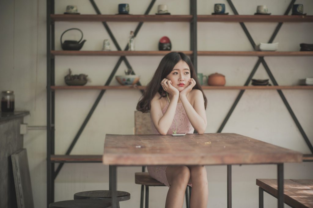 woman pondering how long do hearing aids last