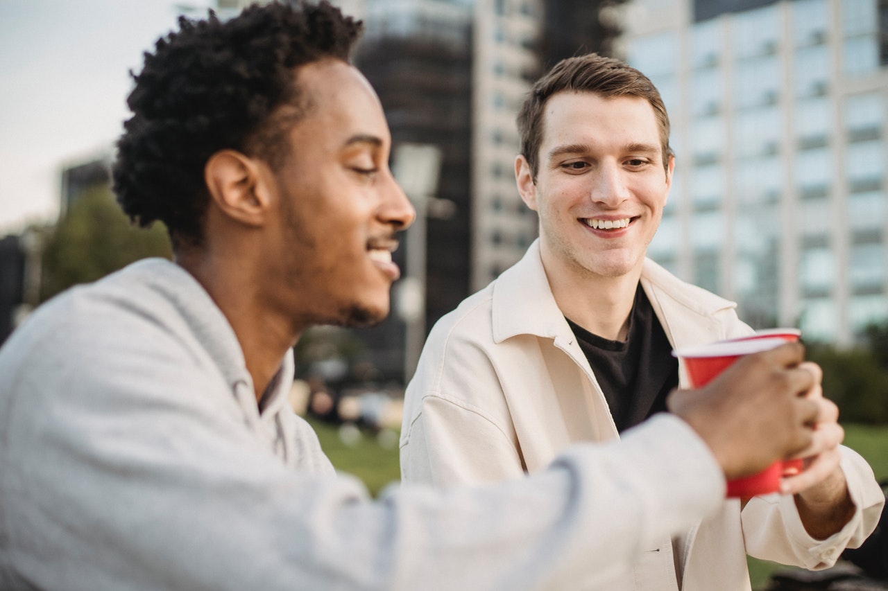 Two Friends Talking In The Ear Hearing Aid